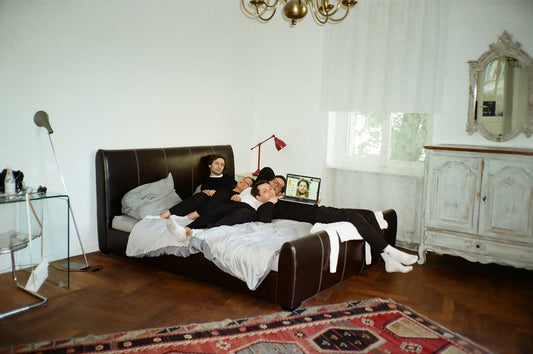 woman lying on black leather bed
