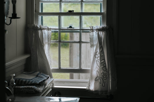 white floral window curtain on window