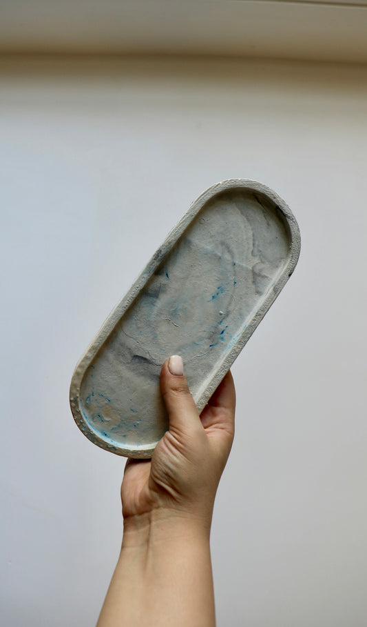 a hand holding a tray of food in the air