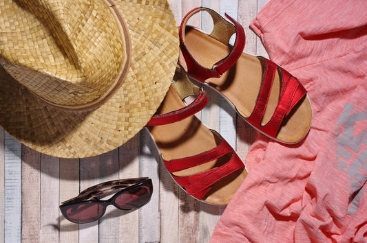 a straw hat, sunglasses and a pair of red sandals