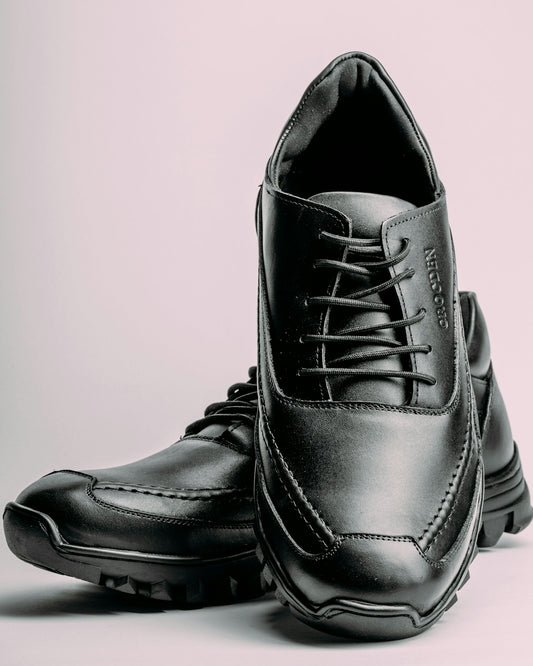 a pair of black shoes on a white background