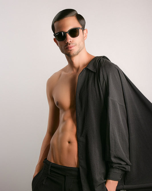 a man wearing sunglasses posing for the camera