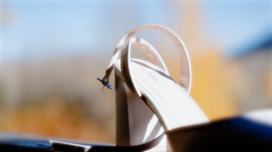 a pair of white shoes sitting on top of a table