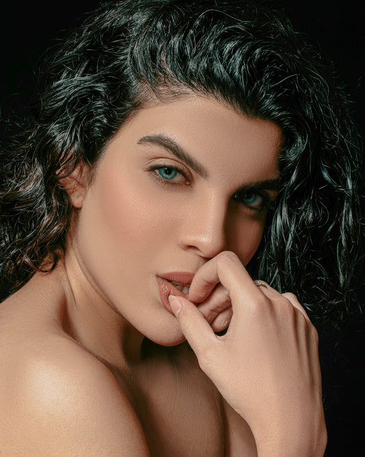 a woman with curly hair posing for a picture