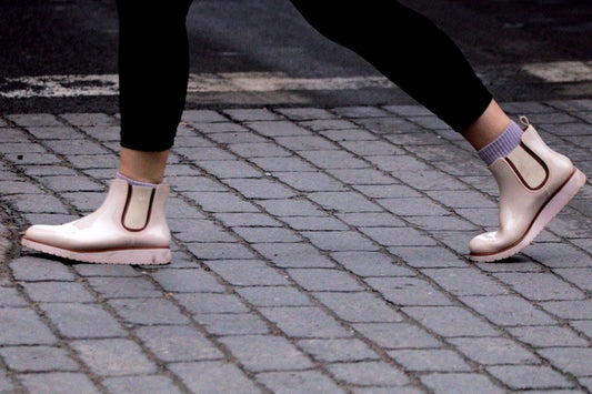 a close up of a person's shoes on a sidewalk