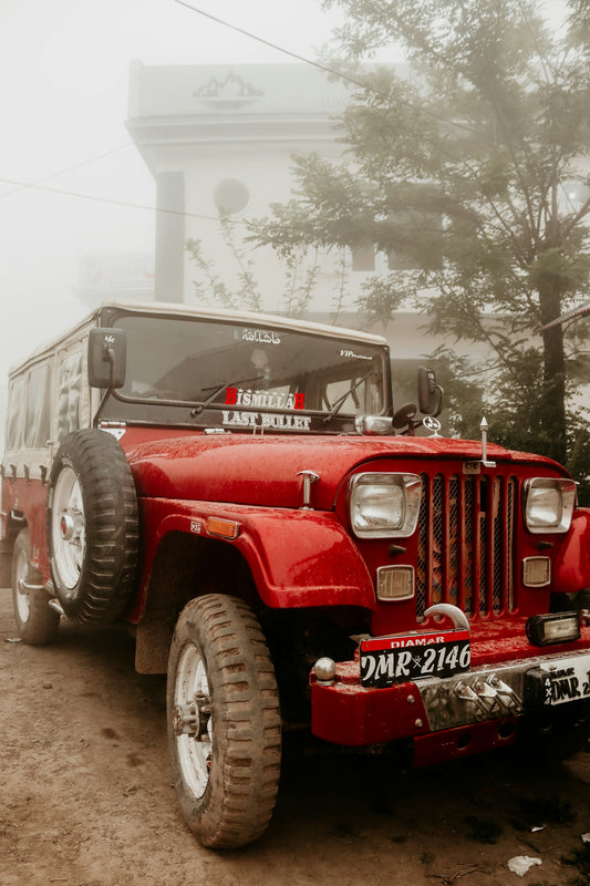 A red jeep parked in front of a building