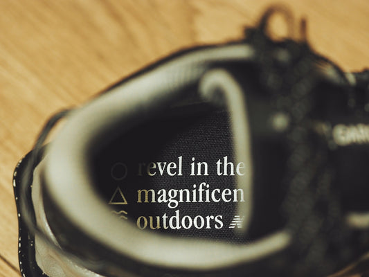 A close up of a shoe on a wooden floor