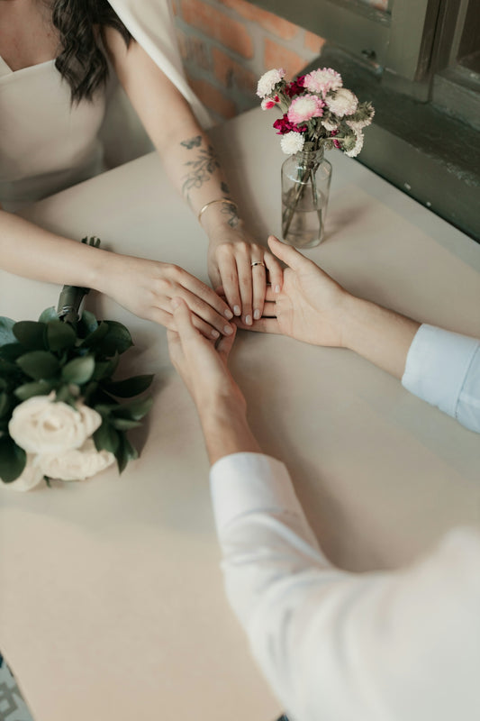 Couple holds hands, perhaps celebrating a special moment.
