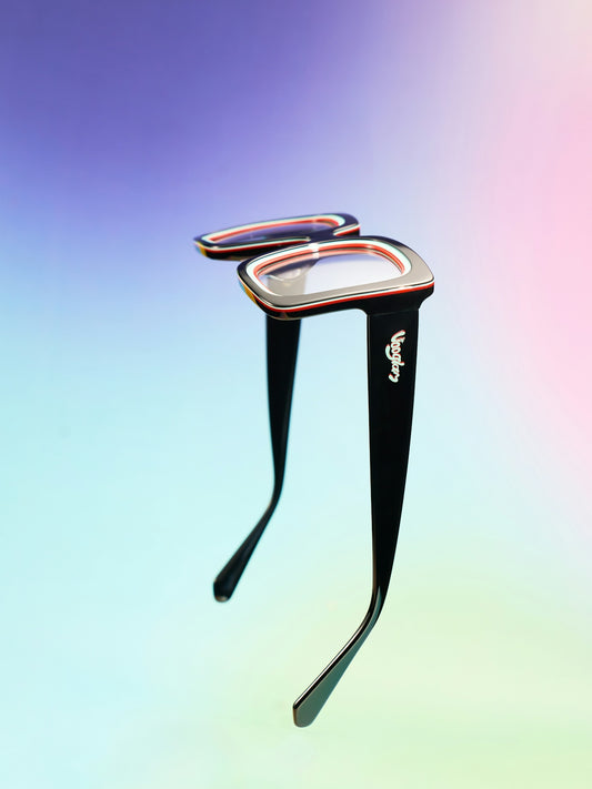 Spectacles are suspended against a colorful background.