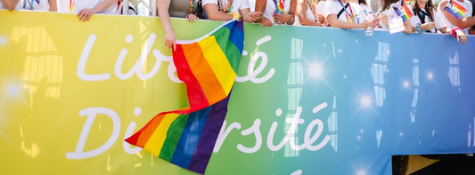Pride flag and sign celebrating diversity and liberty.
