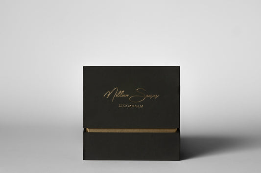 Elegant black box with gold lettering on white background